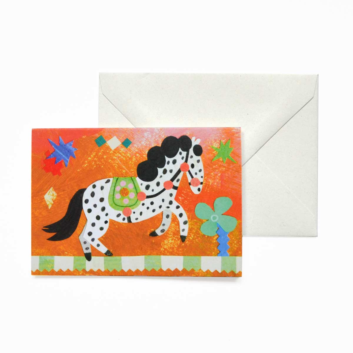 Black and white spotty Circus pony birthday greeting card by Mortlake Papers on orange background