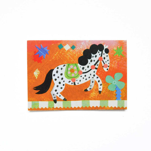 Black and white spotty Circus pony birthday greeting card by Mortlake Papers on orange background.