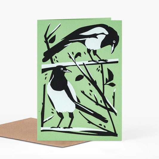 two for joy magpies in black white and green greeting card by pirrip press