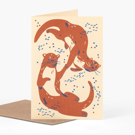otters holding hands in cream orange and blue love greeting card by pirrip press