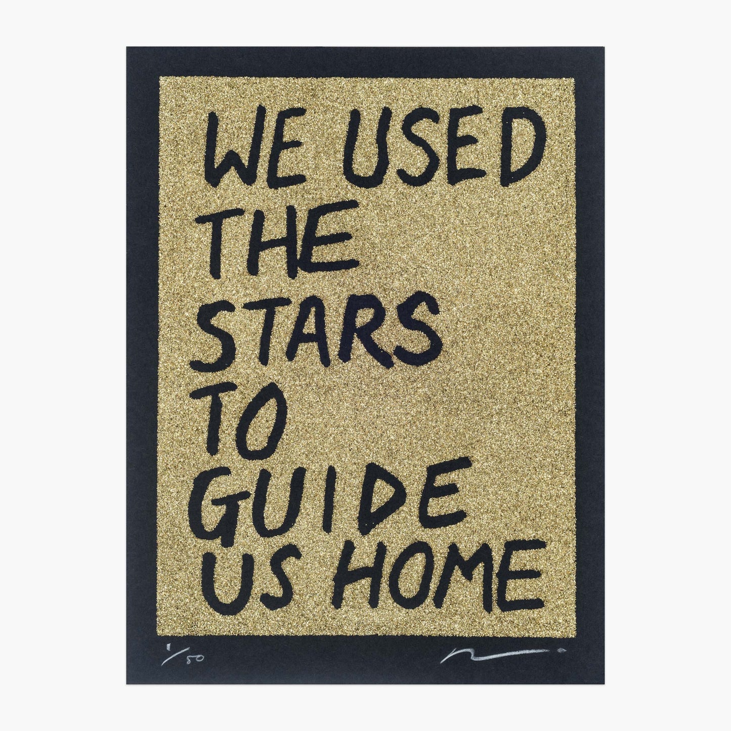 Gold glitter on black paper. Text reads: we used the stars to guide us home in handwritten capitals. By the artist Adam Bridgland and in his signature style