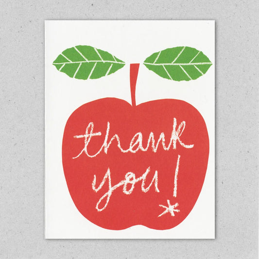 Card with a red apple shape and 'thank you!' text on a gray background by Lisa Jones Studio.