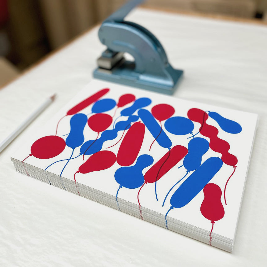 Twenty red and blue balloons in different shapes and sizes original screen printed art print by Crispin Finn on white paper in flat colour vector graphics