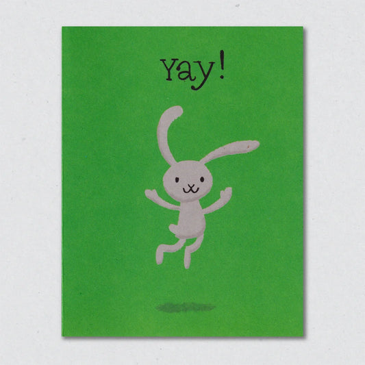 Green Bunny Hop greeting card with a grey rabbit illustration and 'Yay!' text on a light gray background by Lisa Hones Studio