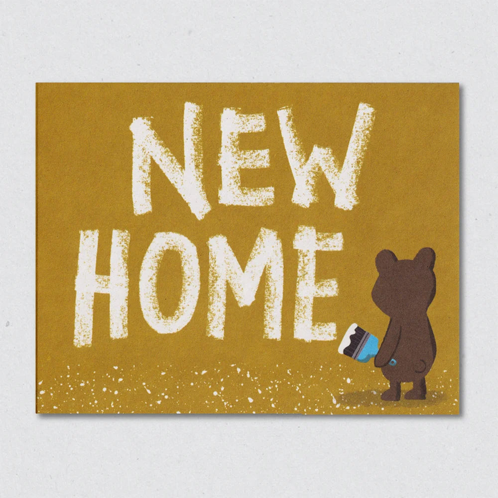 Busy Bear greeting card with 'NEW HOME' text and a bear holding a paintbrush on a mustard background by Lisa Jones Studio.
