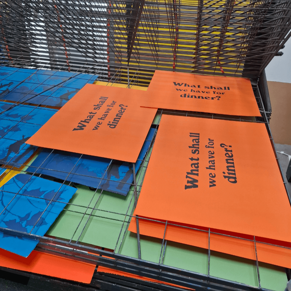 What shall we have for dinner posters in orange by Fiona Hamilton on the drying rack in the print studio.
