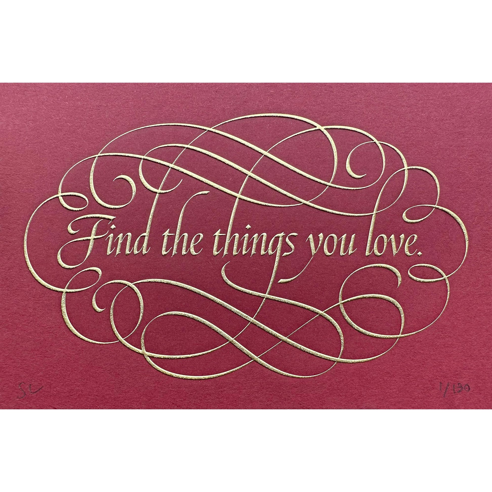 Find the things print by Seb Lester. Die stamp with raised impression. Illustrates the text Find the things you love with flourishes and swirls in gold on red.