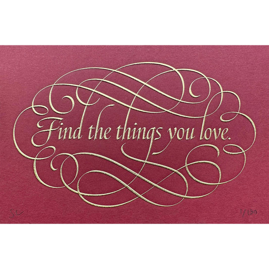 Find the things print by Seb Lester. Die stamp with raised impression. Illustrates the text Find the things you love with flourishes and swirls in gold on red.