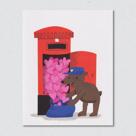 Postbear Valentine's greeting card by Lisa Jones Studio with illustration of a bear with a blue hat placing pink hearts into a red mailbox on a white background.