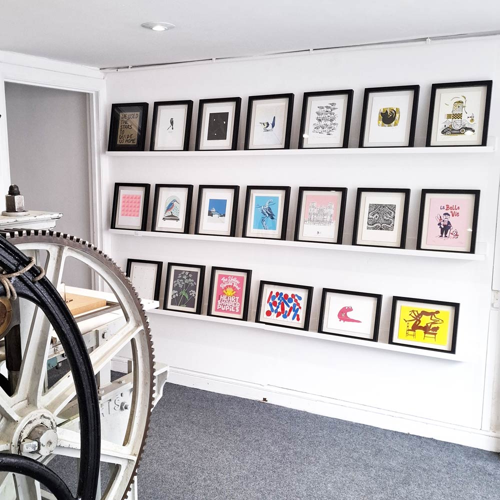 Frames on shelves showing Soma 20 years editions at Frankenstein Press with the Press in the foreground.