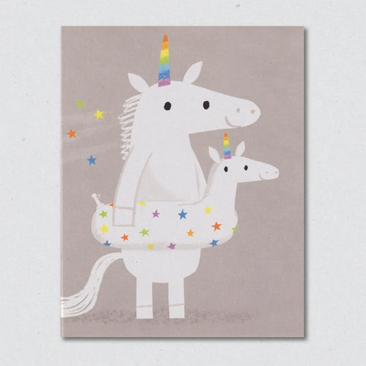 Greeting card with illustration of a unicorn and a smaller unicorn rubber ring on a beige background by Lisa Jones Studio.