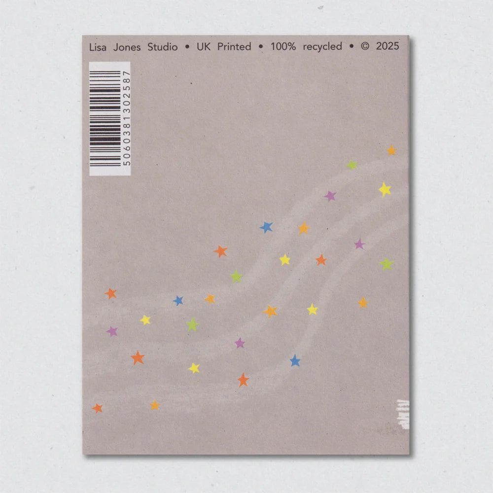 Back of a greeting card with colorful star patterns and a barcode on a gray background by Lisa Jones Studio.