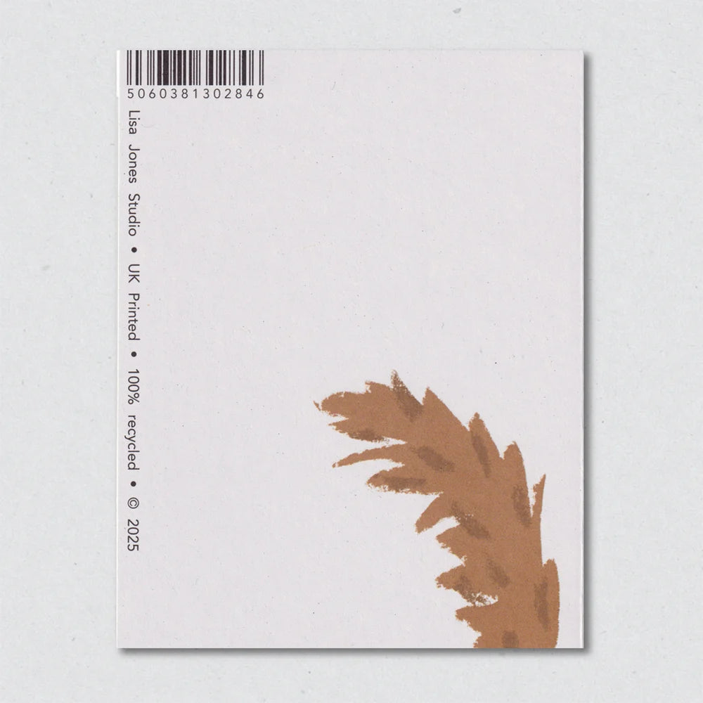 Back of a card with a brown dog tail design and barcode on a light gray background by Lisa Jones Studio.
