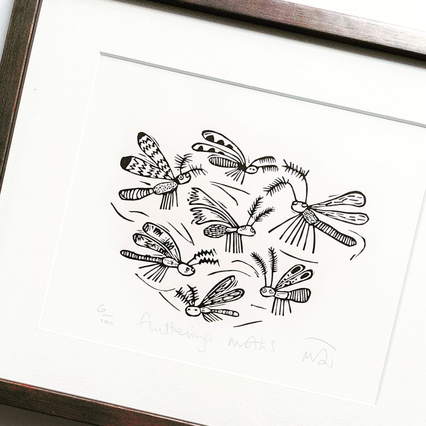 Fluttering moths linocut print by Melanie Wickham.