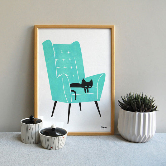 Cat Nat a3 risograph print by Peski Studio featuring a black catnon a turquoise Armchair.