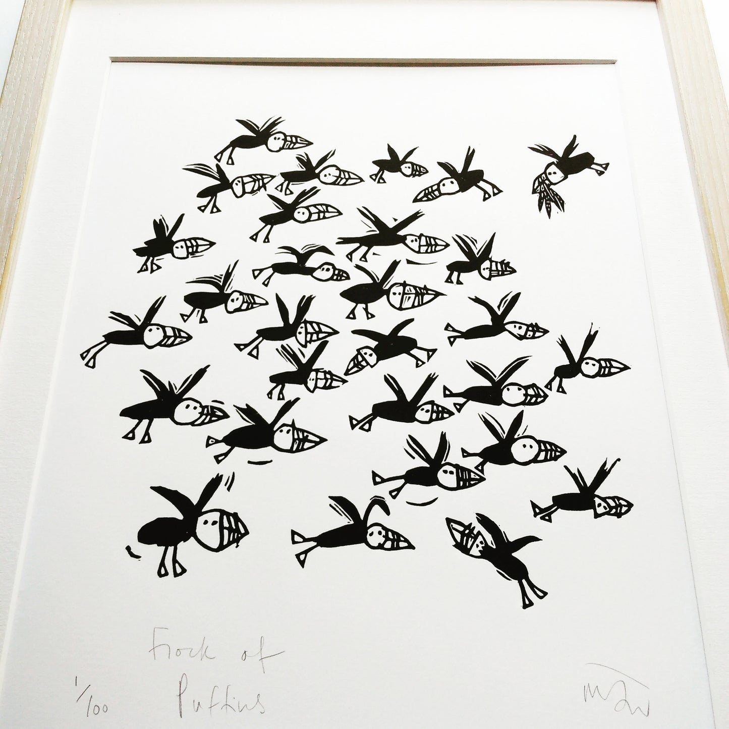 Flock of Puffins lino cut by Melanie Wickham.