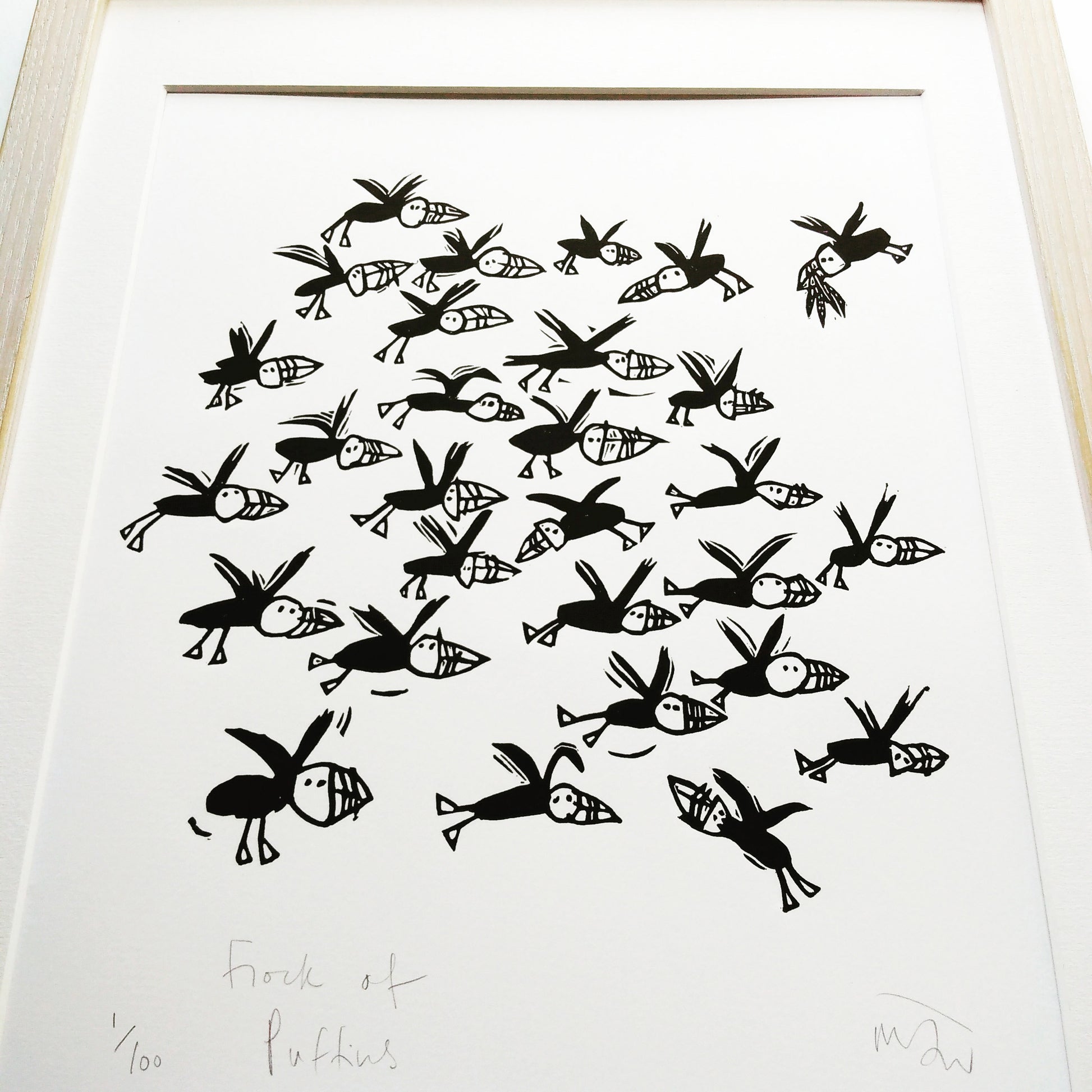Flock of Puffins lino cut by Melanie Wickham.