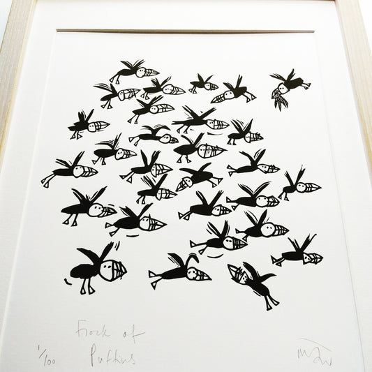 Flock of Puffins lino cut by Melanie Wickham.