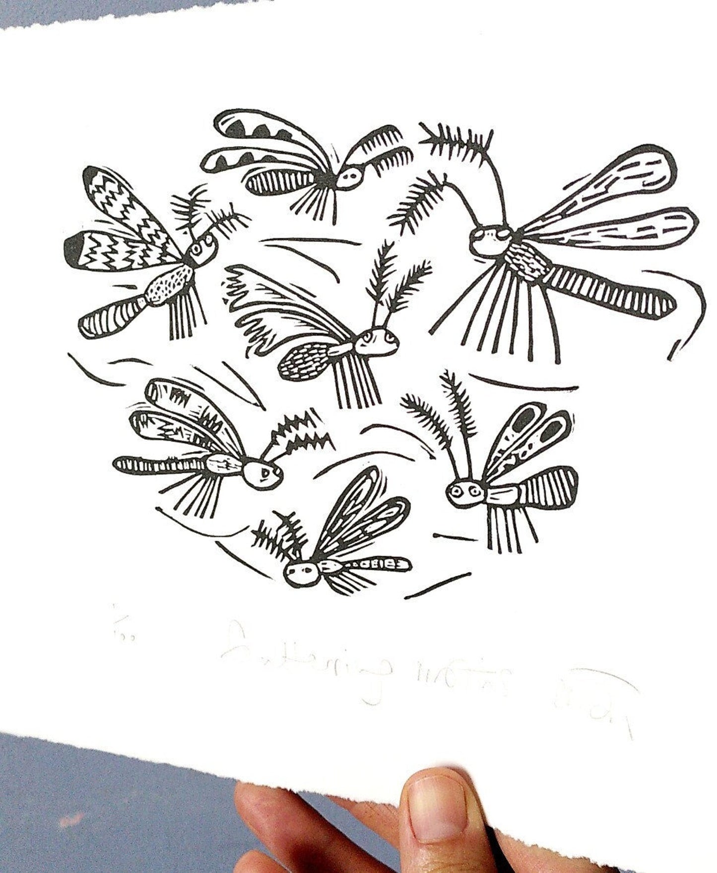 Fluttering moths linocut print by Melanie Wickham.