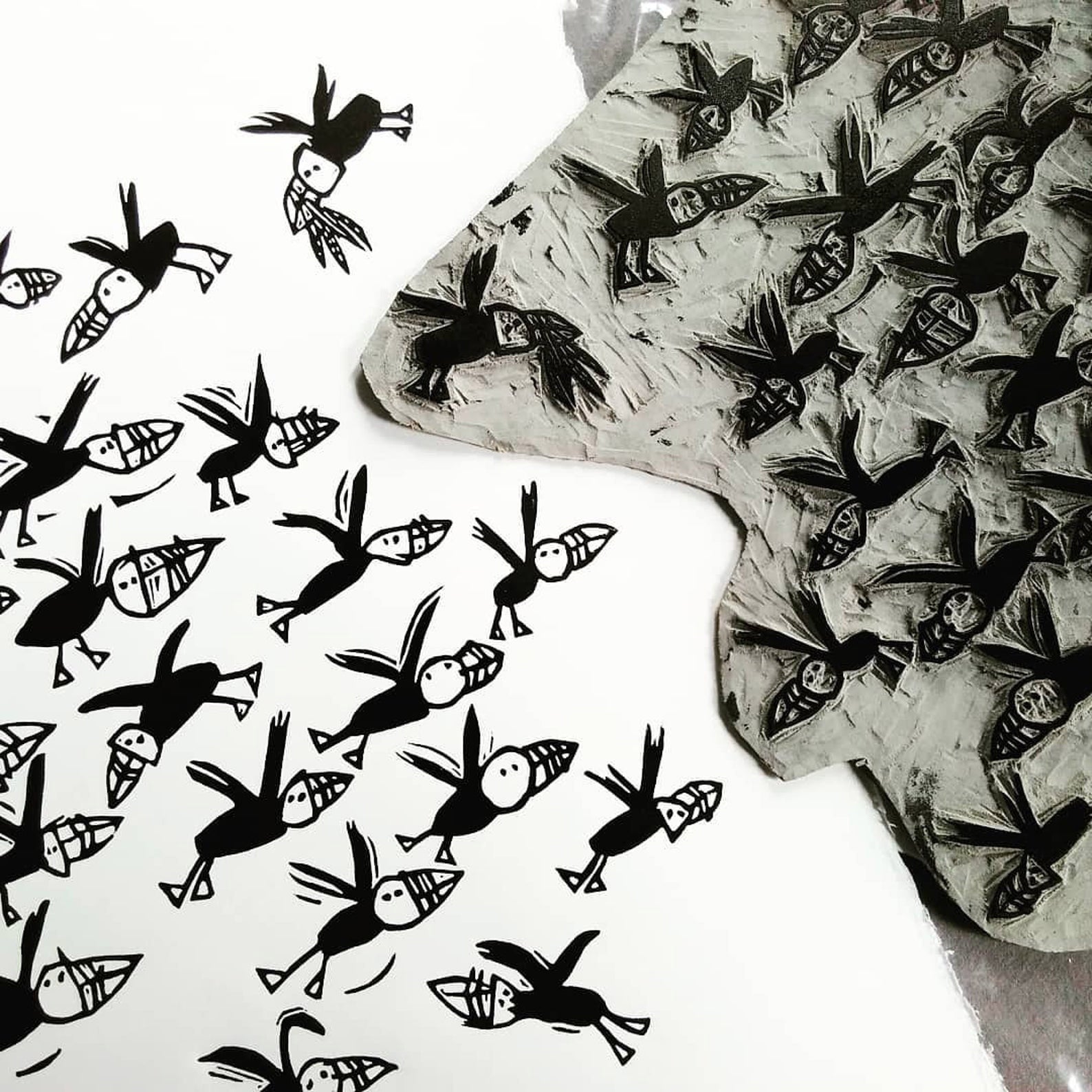 Flock of Puffins lino cut by Melanie Wickham.