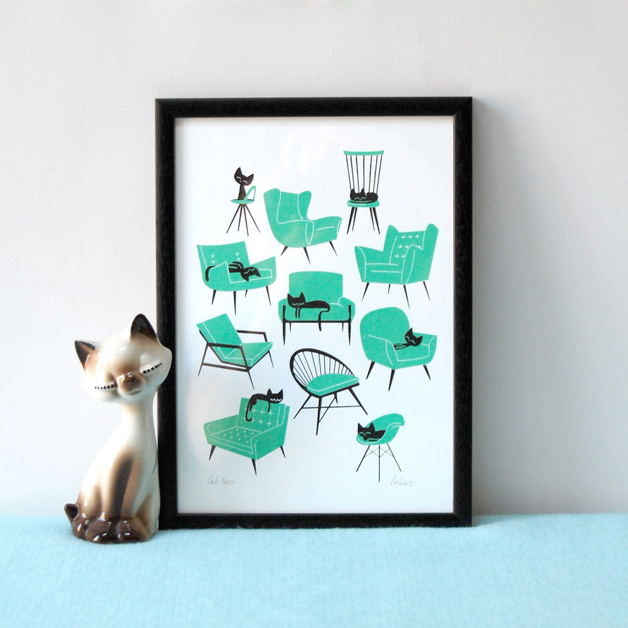 Cat naps screen print by Peski Studio featuring black cats in different positions on different chairs and sofas in turquoise.