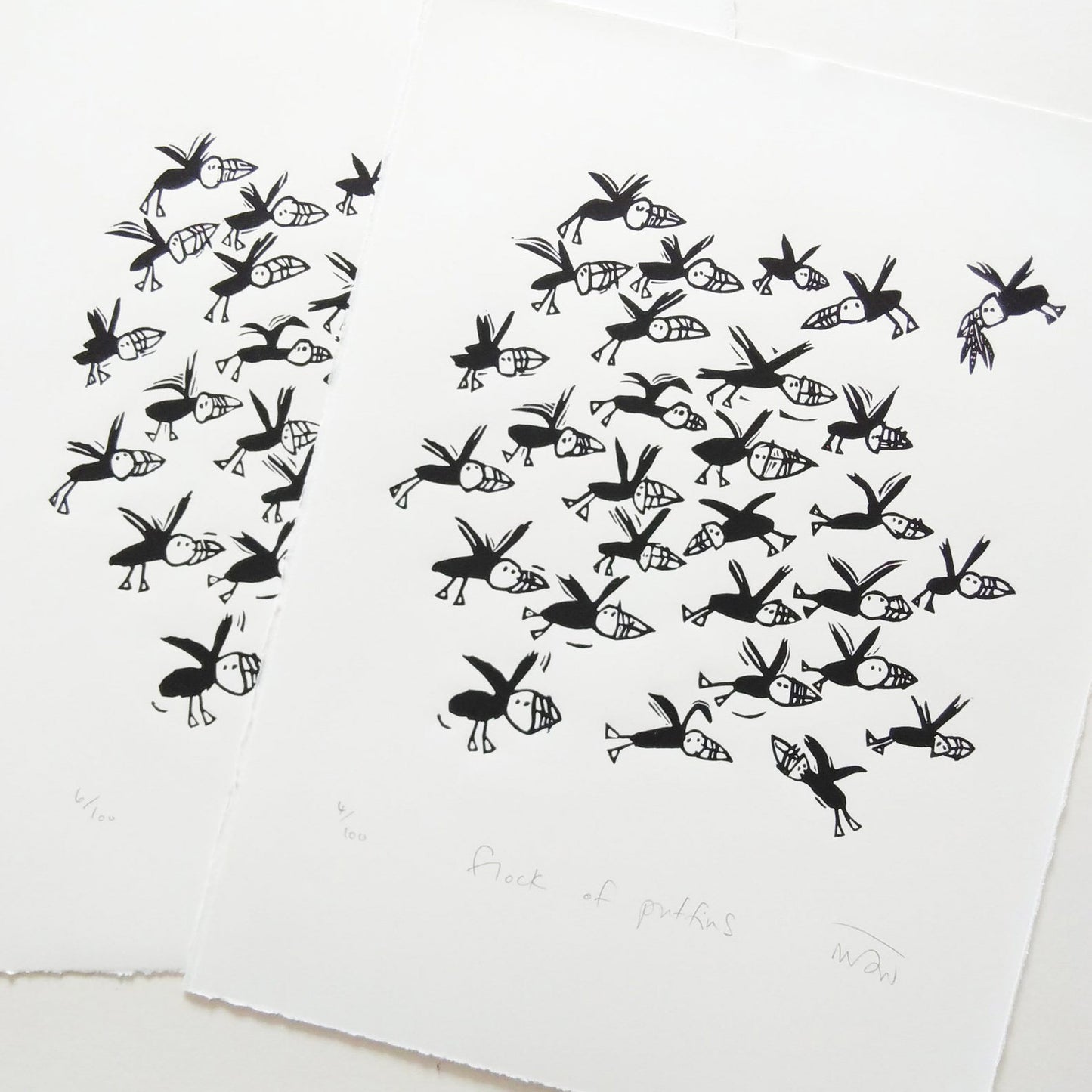 Flock of Puffins lino cut by Melanie Wickham.