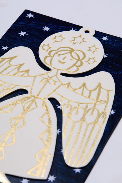 Christmas tree angel decoration by Mortlake Papers in gold on a blue background with white stars