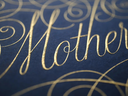 Cursive die stamped artwork by Seb lester. Featuring ornate swirls and swooshes around a swearword. Gold ink on blue paper.