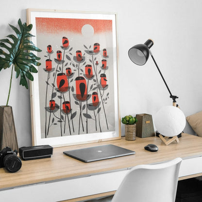 Modern home office desk with a laptop, lamp, and framed 'Siskin Tree' original screen print by contemporary printmaker and artist, Graham Carter, on a white wall.