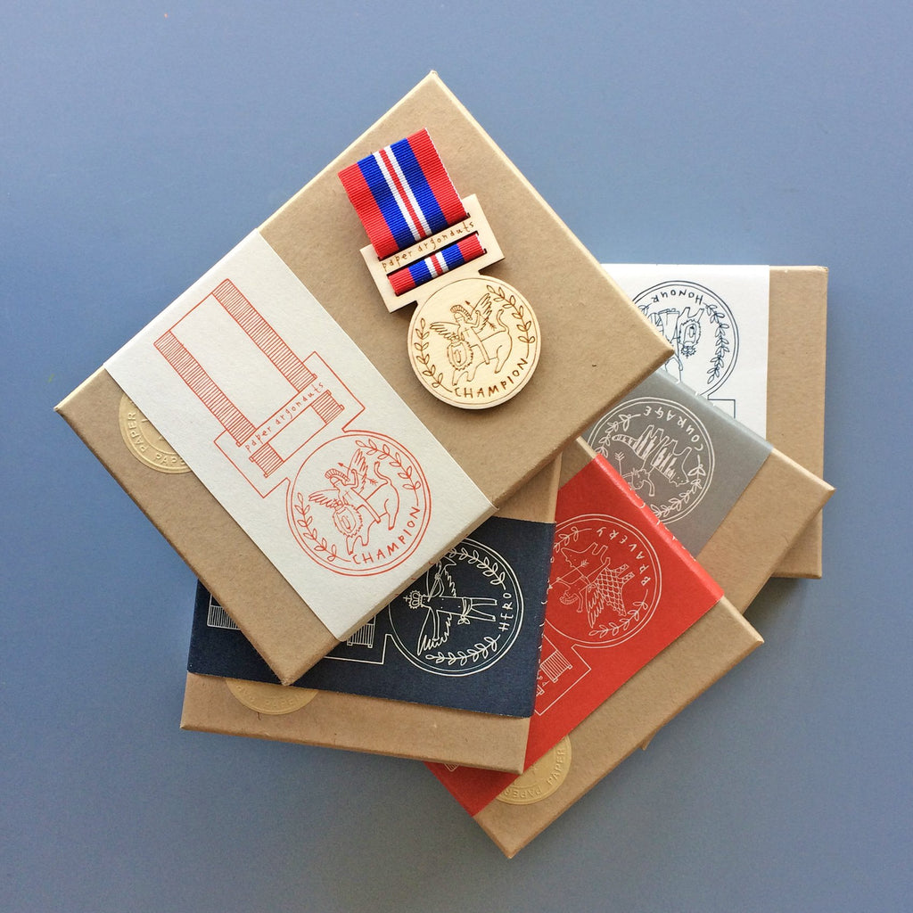 Limited edition wooden medals by Fiona Biddington aka Paper Argonauts at Soma Gallery