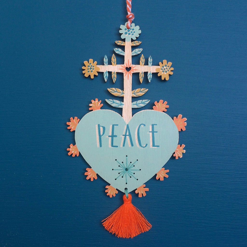 Laser cut and screen printed 'Peace' Milagro charm in aqua by Fiona Biddington aka Paper Argonauts at Soma Gallery